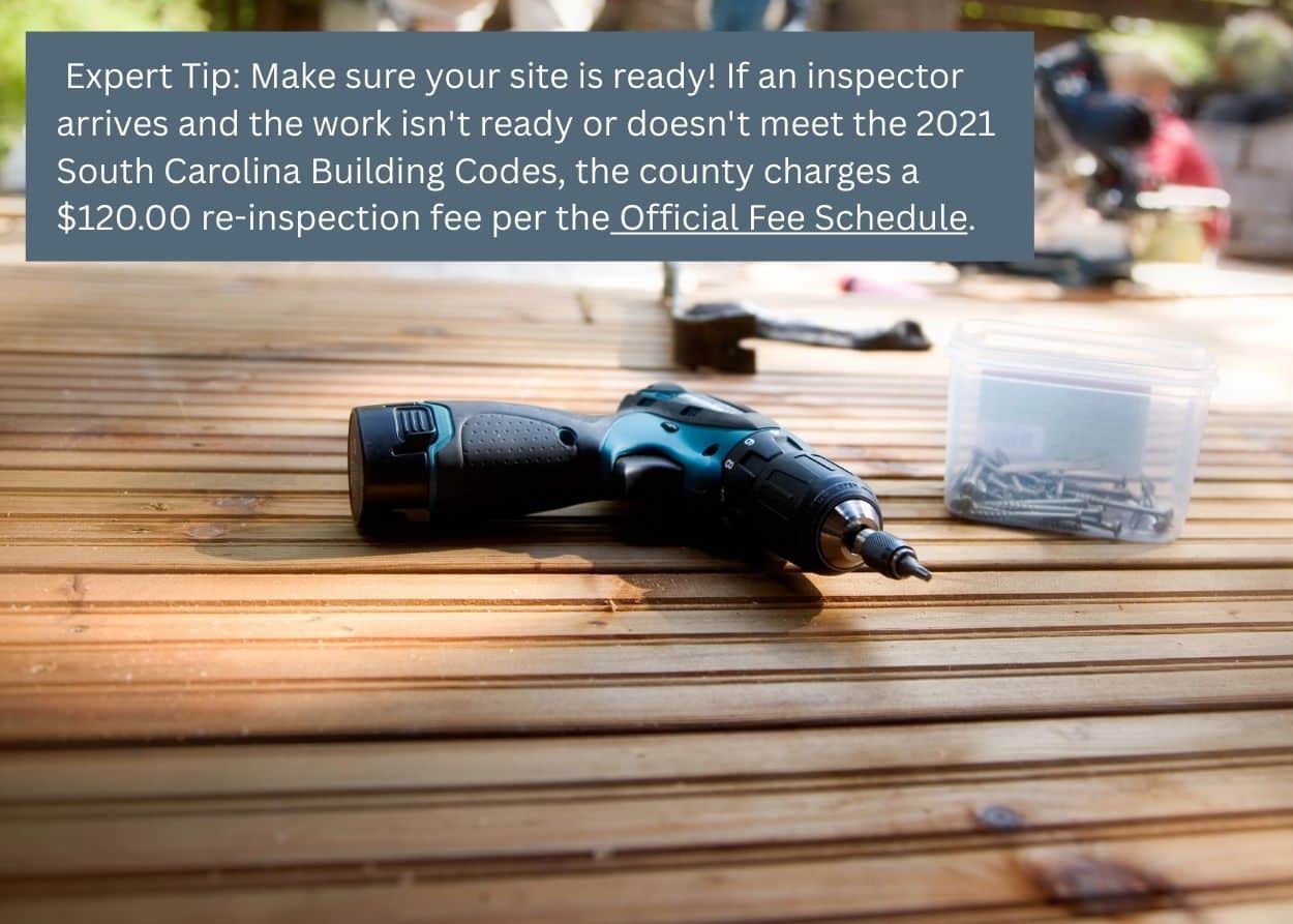 Close-up of deck construction tools and fasteners during installation, representing inspection and code compliance for deck building in Greenville County. Caption: Expert Tip: Make sure your site is ready! If an inspector arrives and the work isn't ready or doesn't meet the 2021 South Carolina Building Codes, the county charges a $120.00 re-inspection fee per the Official Fee Schedule.