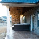 Covered Stamped Wood-like Concrete Patio with Mason Fireplace