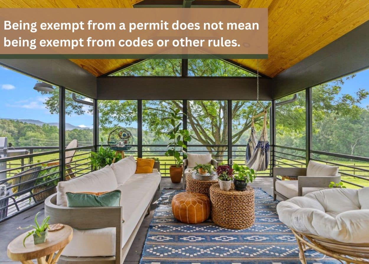 Screened-in porch with seating and scenic outdoor view.